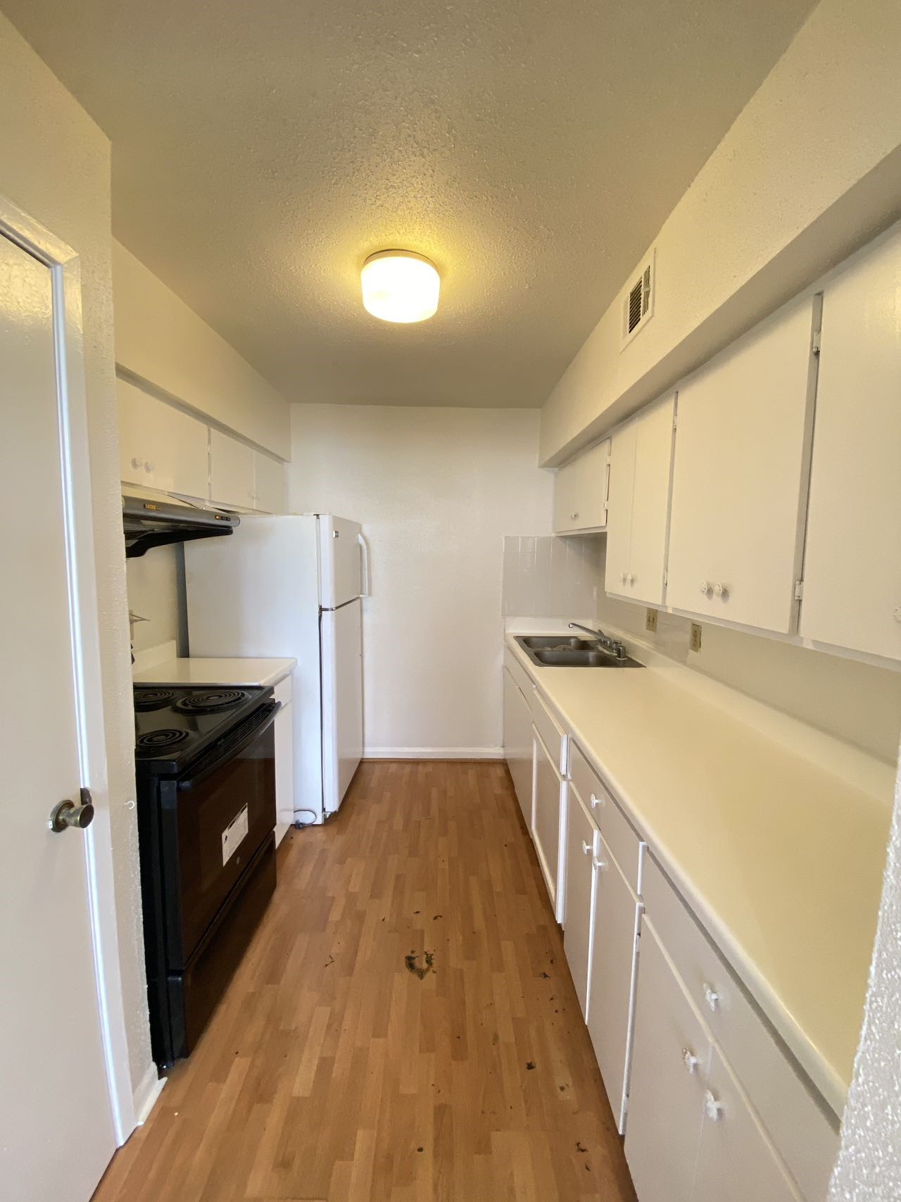6201 Ranchester Drive, Unit 19 Houston, TX 77036 - Photo 9 of 26 a kitchen with granite countertop a sink and a stove top oven