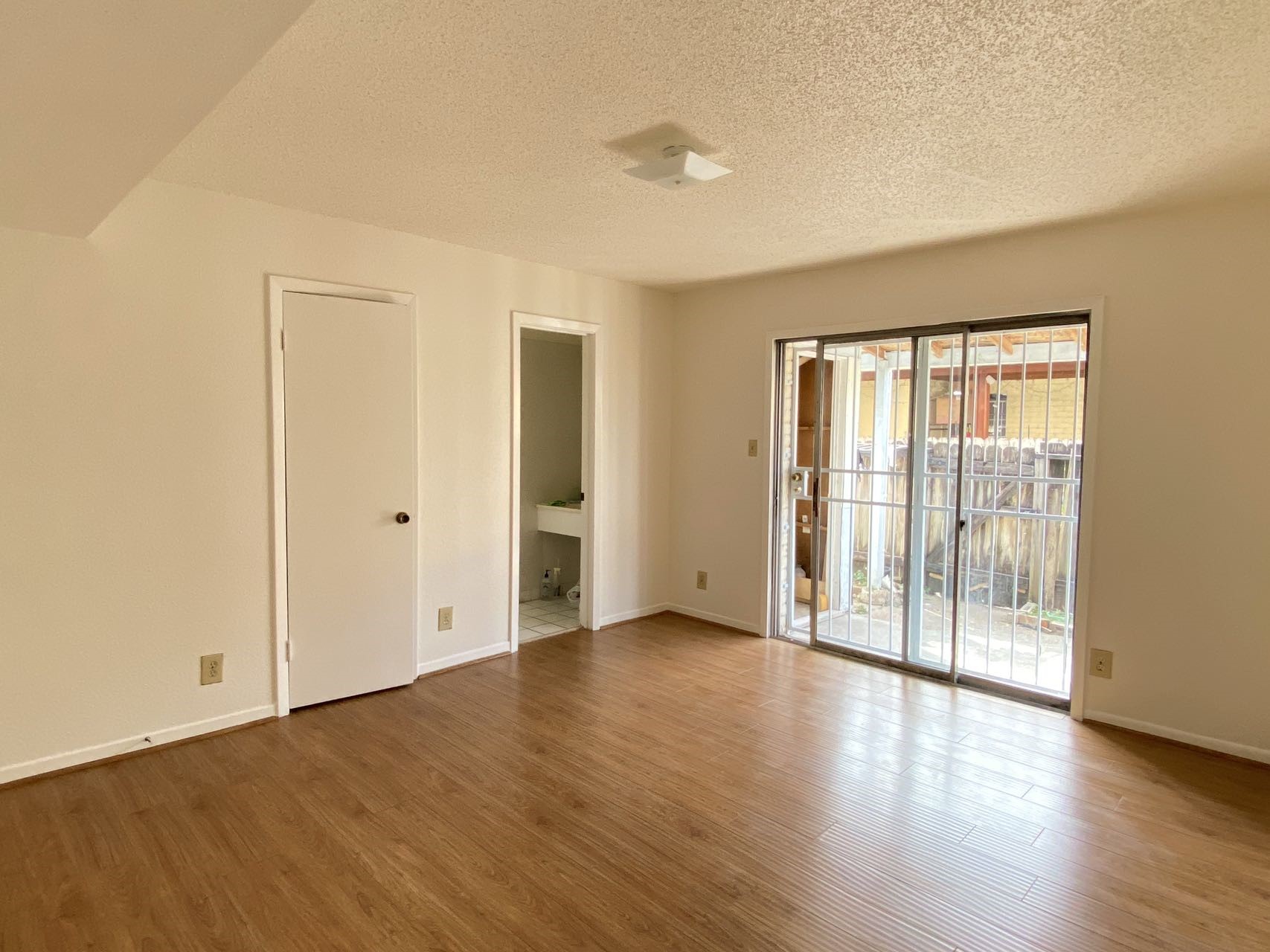 6201 Ranchester Drive, Unit 19 Houston, TX 77036 - Photo 10 of 26 an empty room with wooden floor and windows