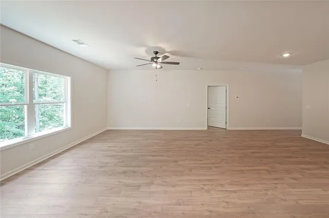 wooden floor in an empty room with a window
