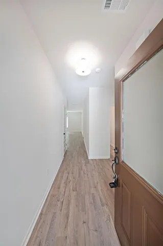 a view of a room with wooden floor