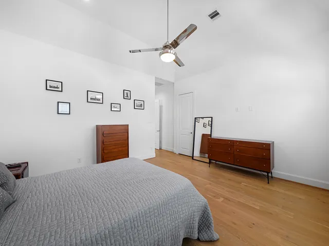 a bedroom with a bed and a dresser