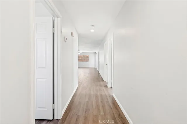 a view of a hallway with wooden floor