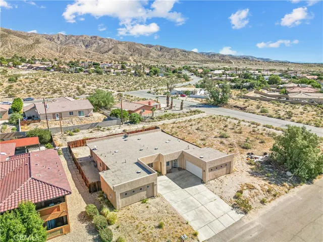 an aerial view of residential houses with outdoor space