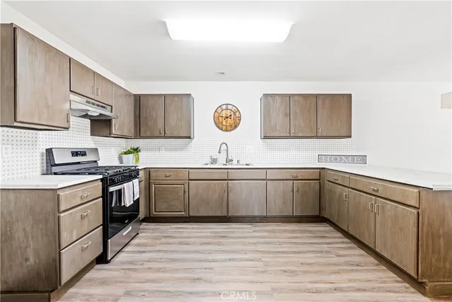 a kitchen with a sink cabinets and stainless steel appliances
