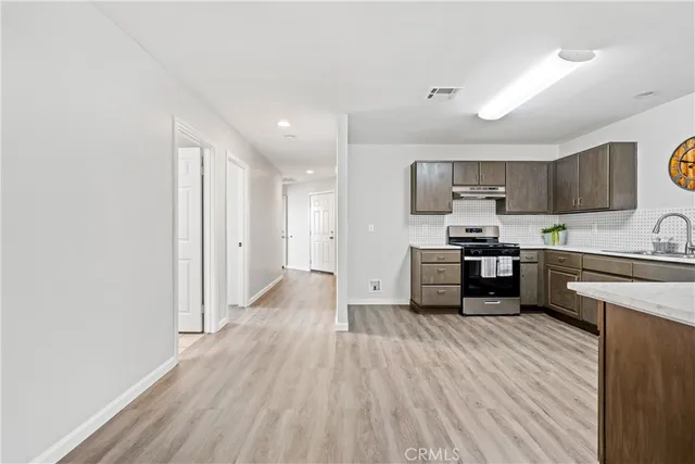 a kitchen with stainless steel appliances a refrigerator and a stove top oven