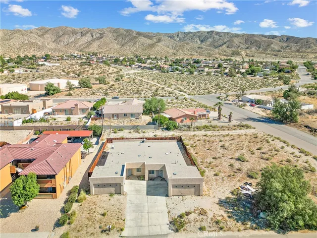 an aerial view of residential houses with outdoor space