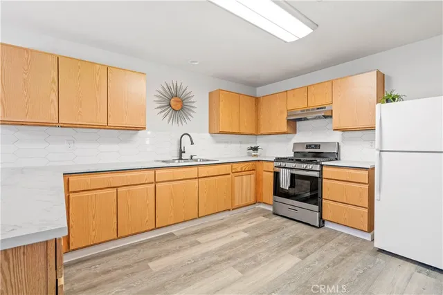 a kitchen with granite countertop white cabinets and white appliances