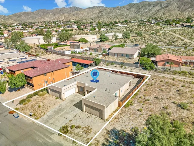 an aerial view of residential houses with outdoor space