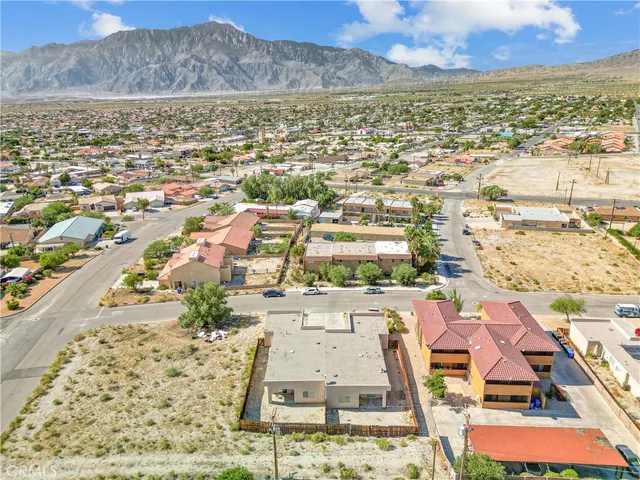 an aerial view of residential houses with outdoor space