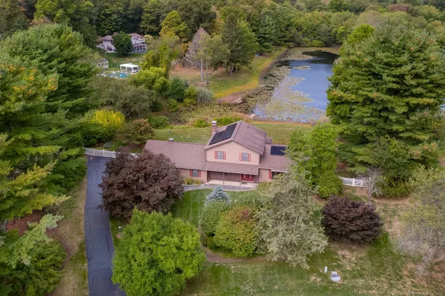 an aerial view of a house with a lake view
