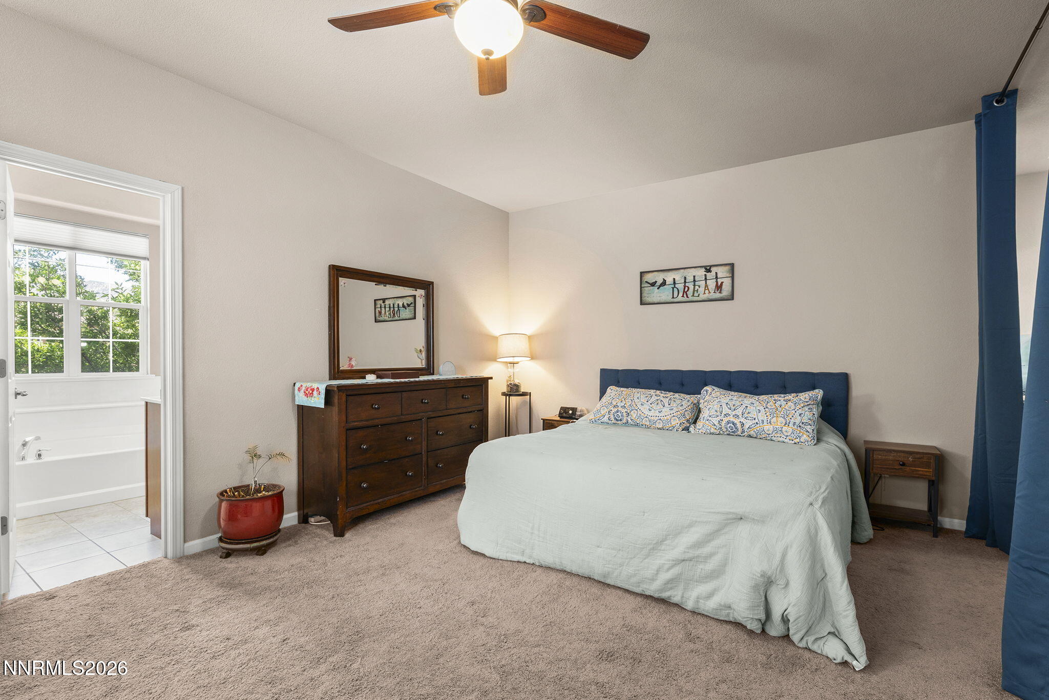 11041 Colton Drive Reno, NV 89521 - Photo 14 of 28 a bedroom with a bed and a chandelier