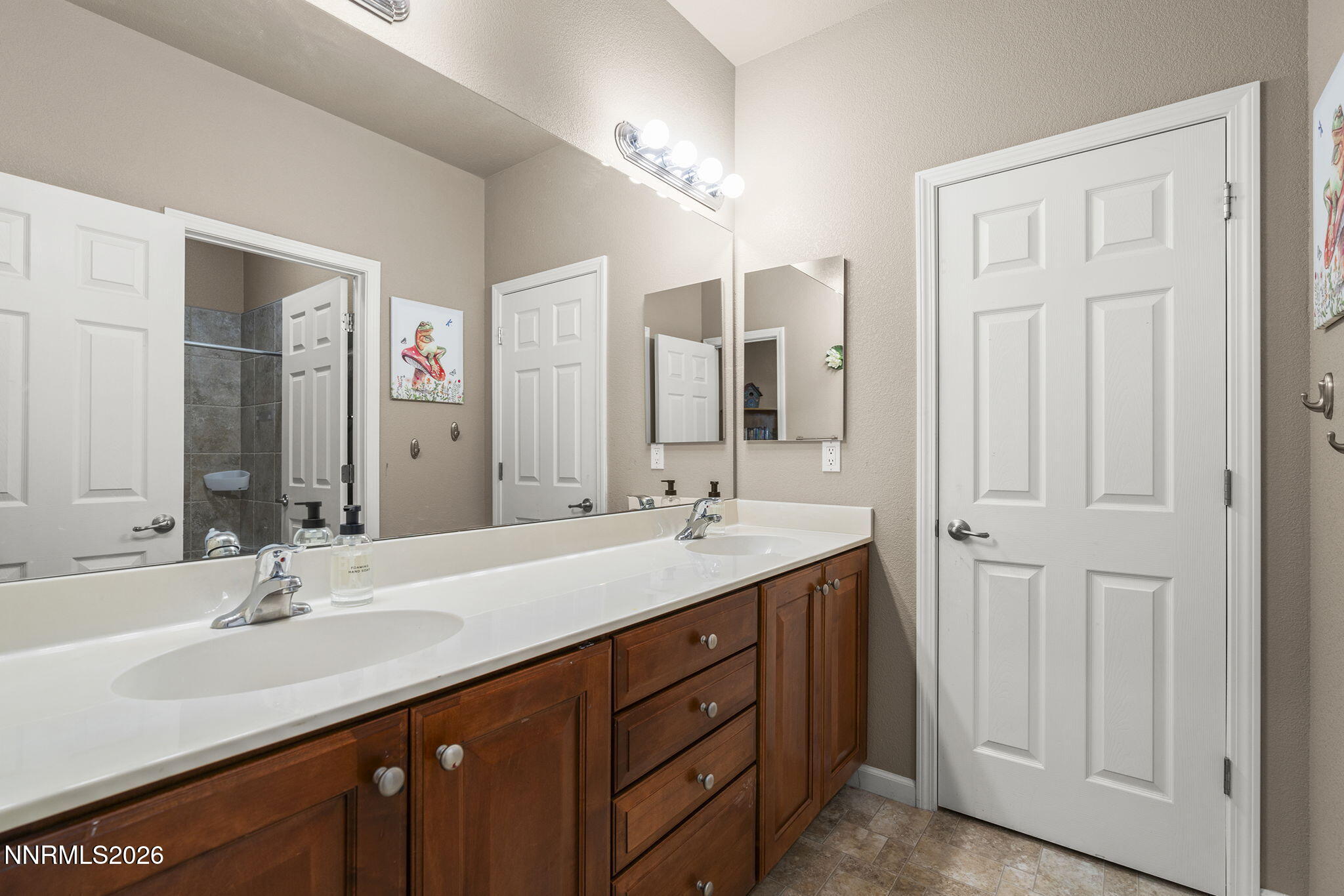 11041 Colton Drive Reno, NV 89521 - Photo 20 of 28 a bathroom with a double vanity sink and a mirror