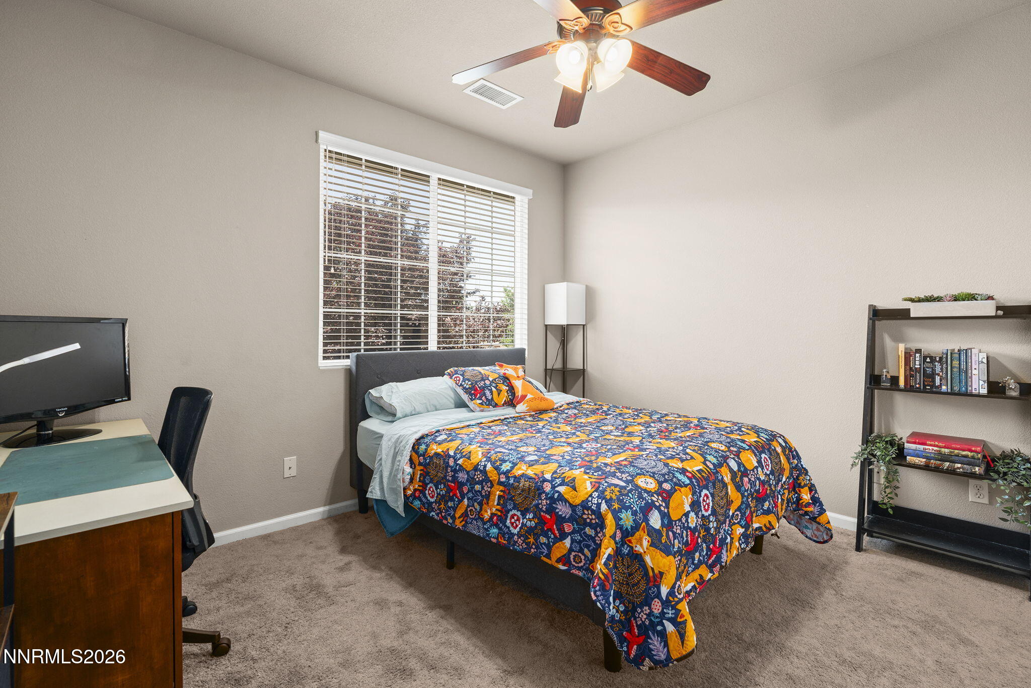 11041 Colton Drive Reno, NV 89521 - Photo 21 of 28 a bedroom with a bed and a chandelier
