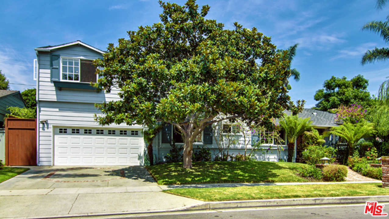 a view of a house with a tree in the background
