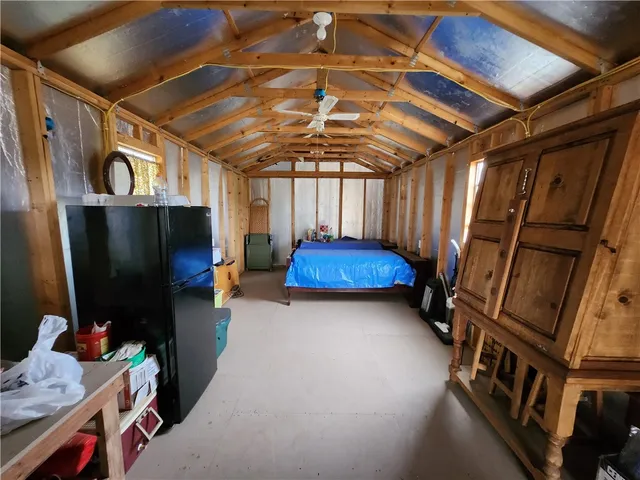 a room with furniture and a refrigerator