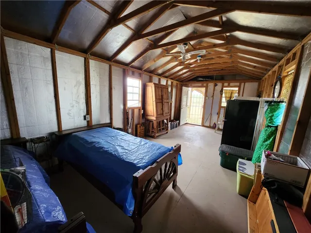 a bedroom with a bed and a flat tv screen