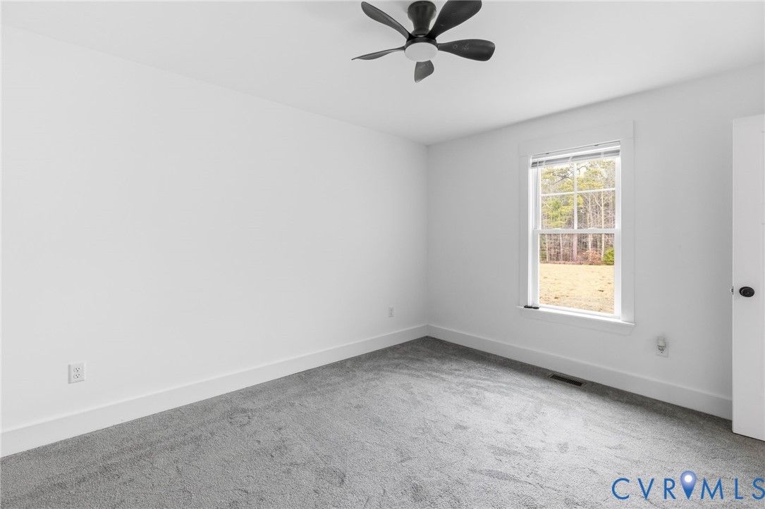 5245 Courtland Road Disputanta, VA 23842 - Photo 22 of 27 a view of a big room with a window and a ceiling fan