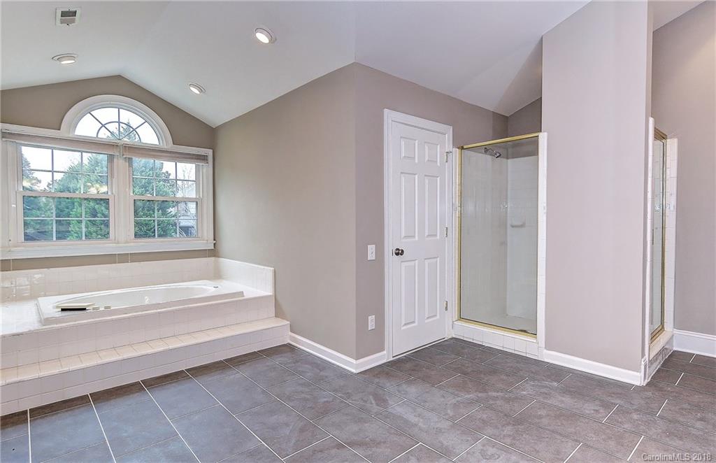3479 Peacock Run Fort Mill, SC 29708 - Photo 14 of 24 a spacious bathroom with a bathtub and a large window