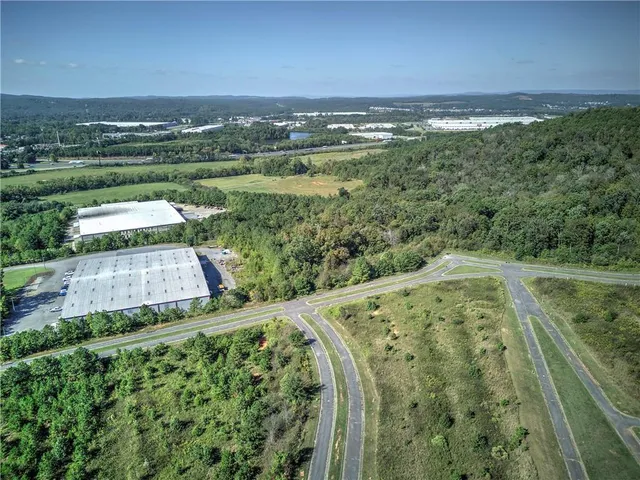 a view of a green field with an ocean view