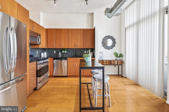 a kitchen with a sink cabinets and stainless steel appliances
