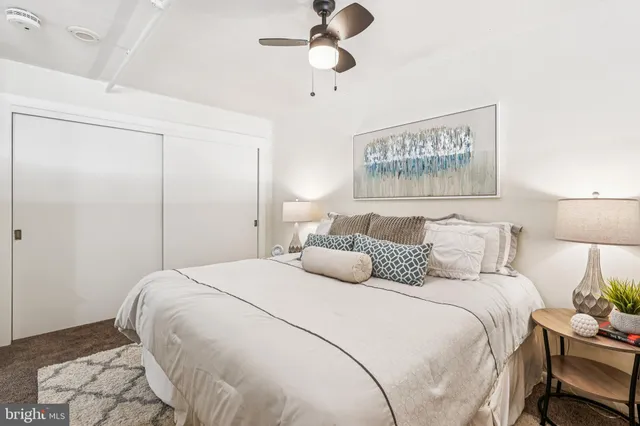 a bedroom with a bed and a lamp