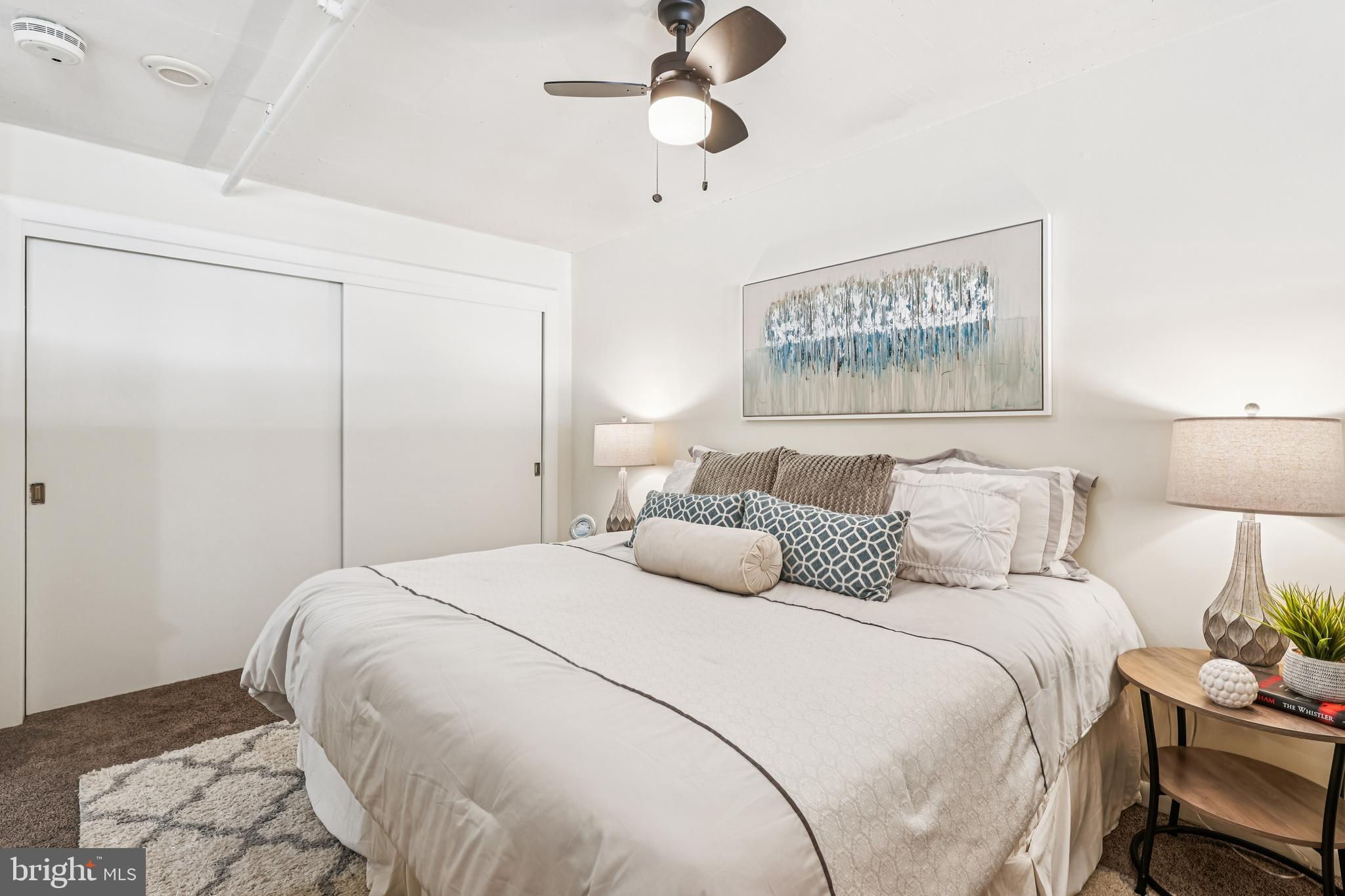 811 4th Street Northwest, Unit 1014 Washington, DC 20001 - Photo 15 of 21 a bedroom with a bed and a lamp