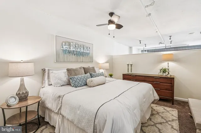 a bedroom with bed and a chandelier