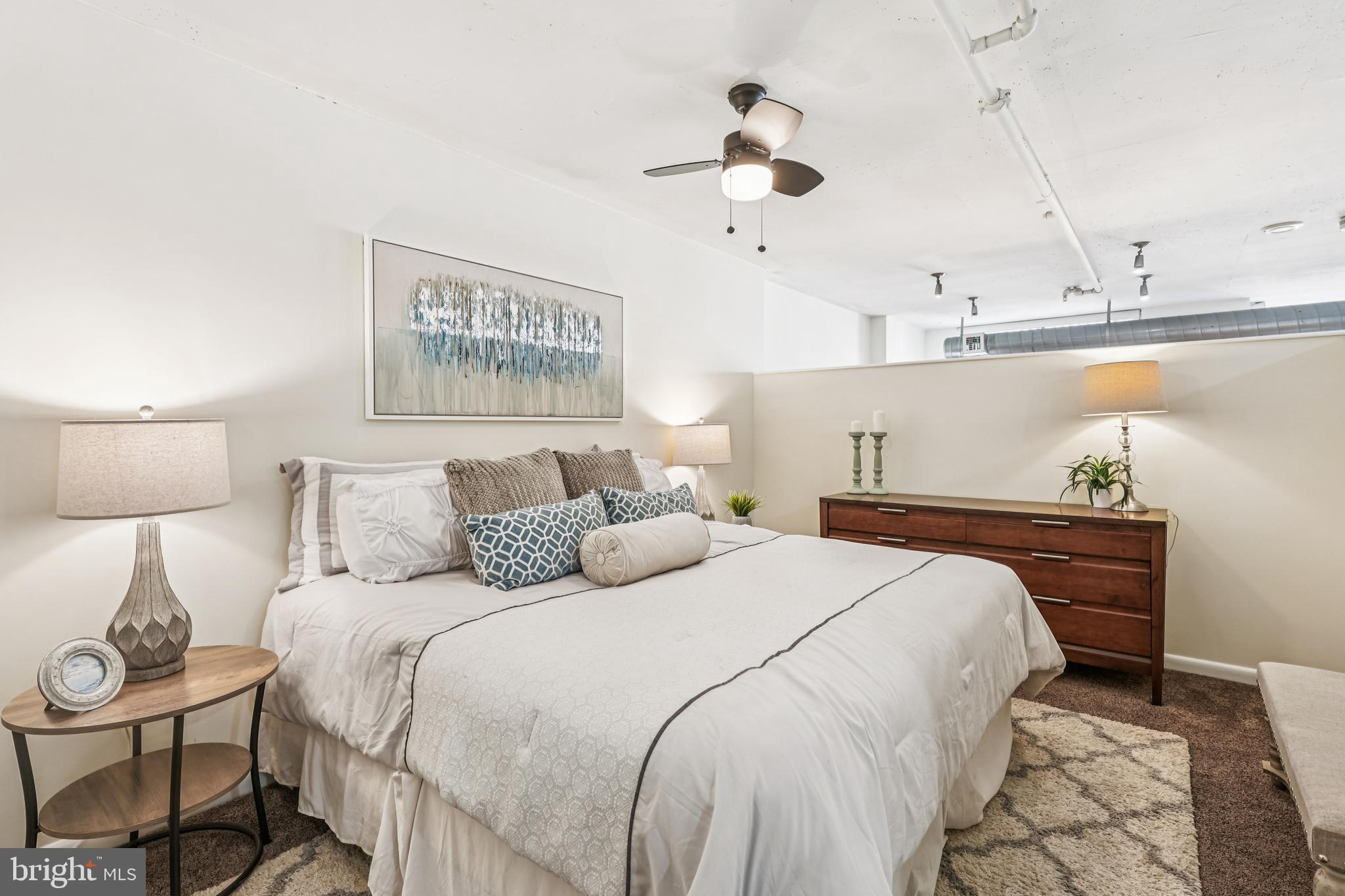 811 4th Street Northwest, Unit 1014 Washington, DC 20001 - Photo 16 of 21 a bedroom with bed and a chandelier
