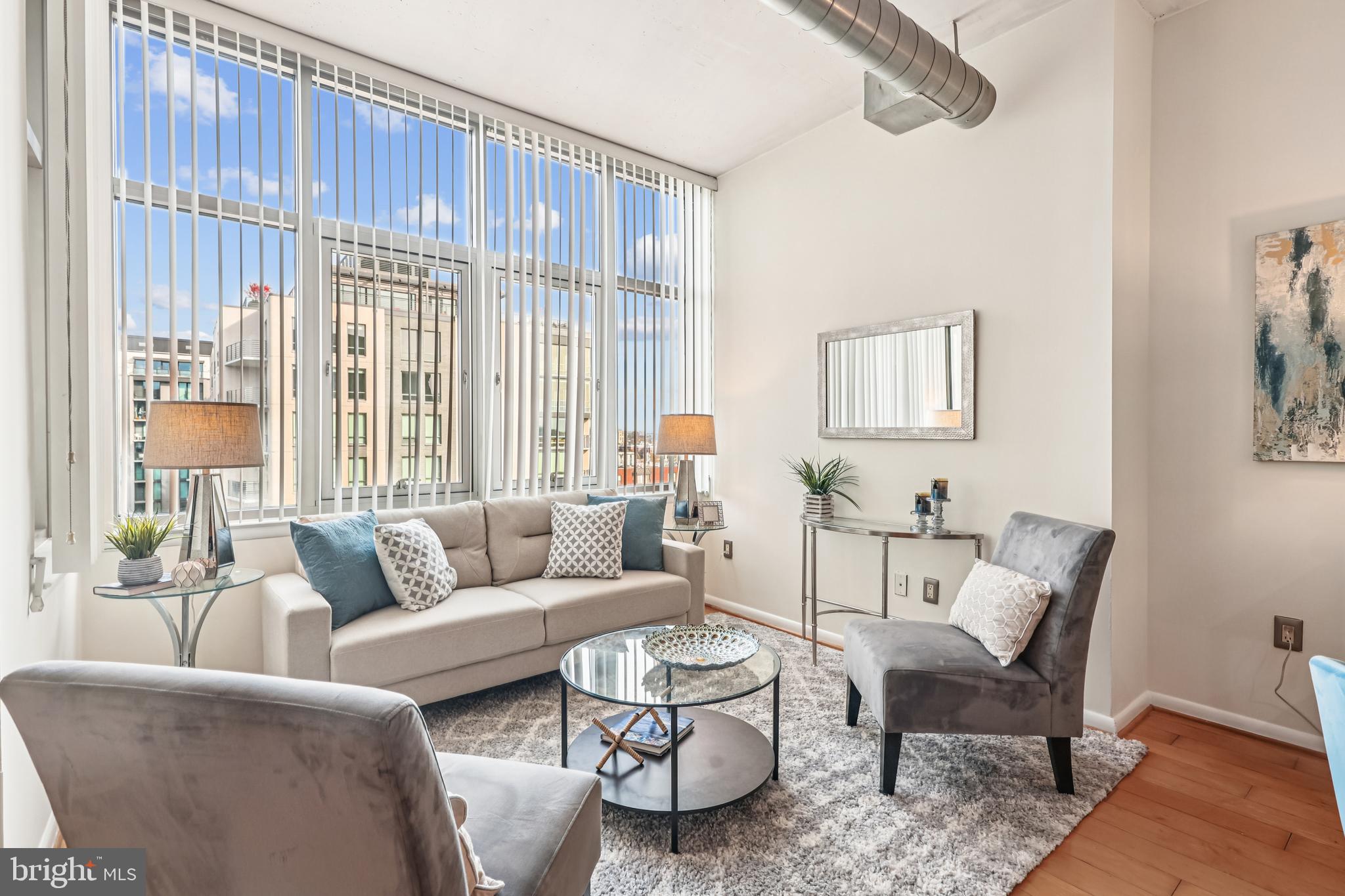 811 4th Street Northwest, Unit 1014 Washington, DC 20001 - Photo 2 of 21 a living room with furniture and a large window
