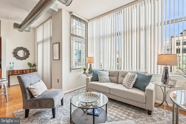 a living room with furniture and a large window