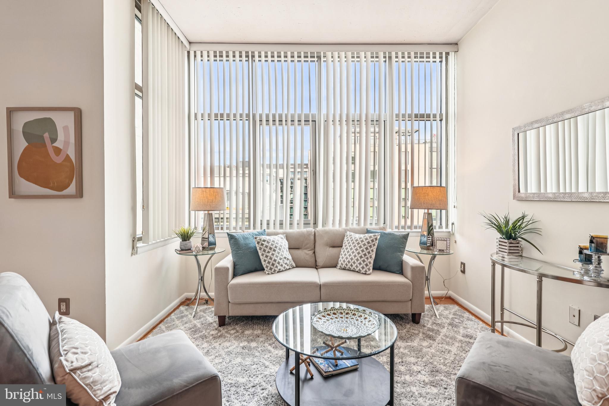 811 4th Street Northwest, Unit 1014 Washington, DC 20001 - Photo 4 of 21 a living room with furniture and a large window
