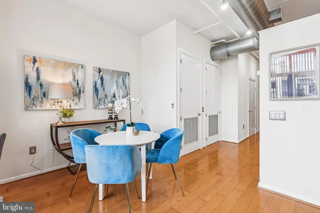 a dining room with furniture and wooden floor