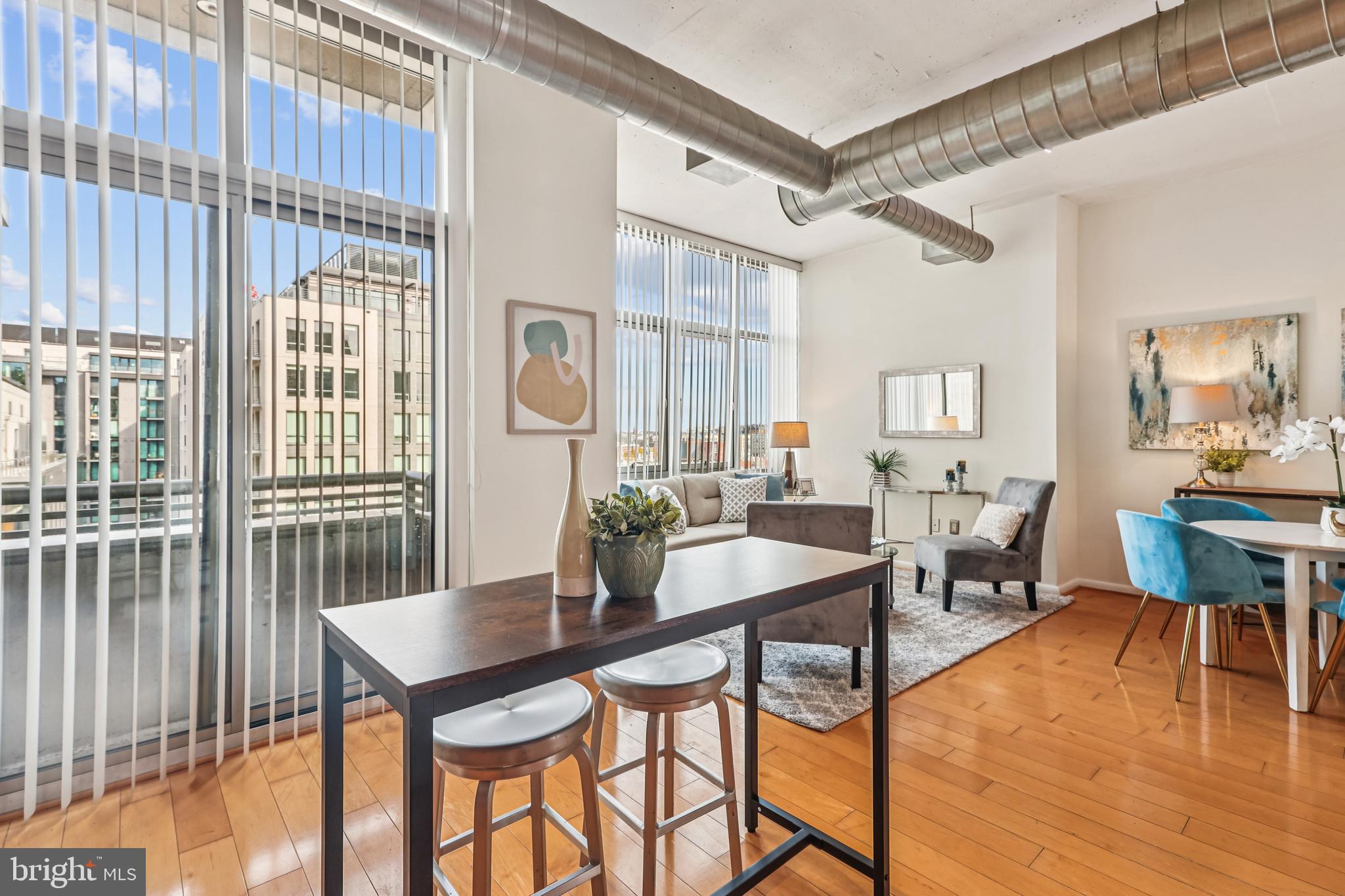 811 4th Street Northwest, Unit 1014 Washington, DC 20001 - Photo 10 of 21 a view of a dining room with furniture and wooden floor
