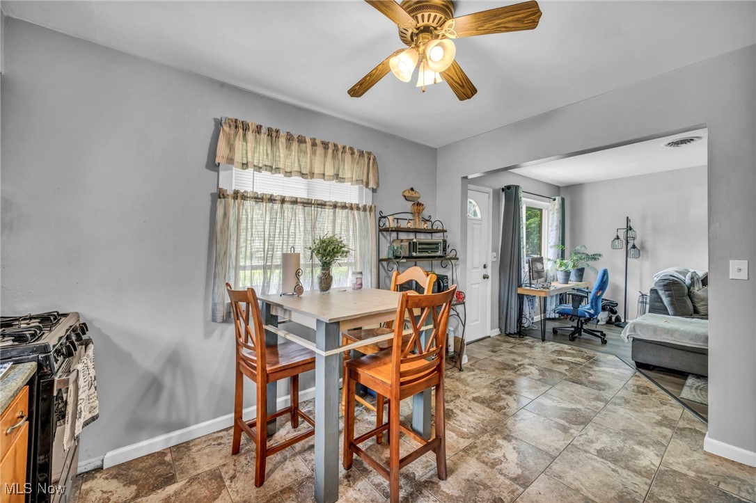 7515 Maddock Road North Ridgeville, OH 44039 - Photo 27 of 37 Dining area featuring ceiling fan and stone finish floors
