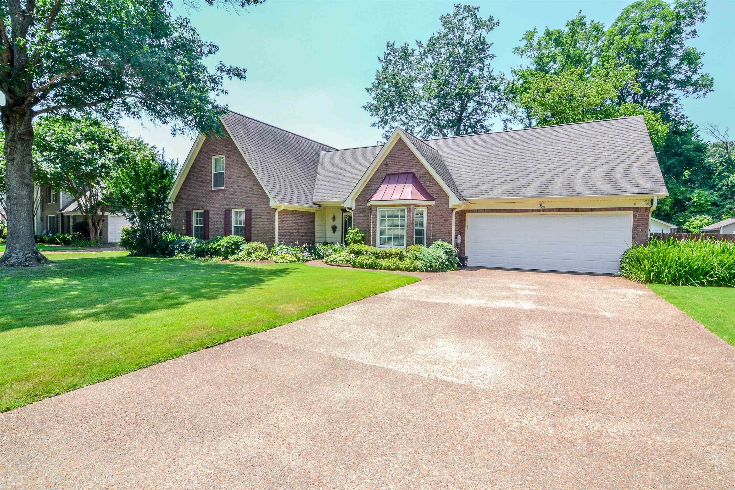 591 Rillbrook Drive Collierville, TN 38017 - Photo 1 of 25 a front view of a house with a yard