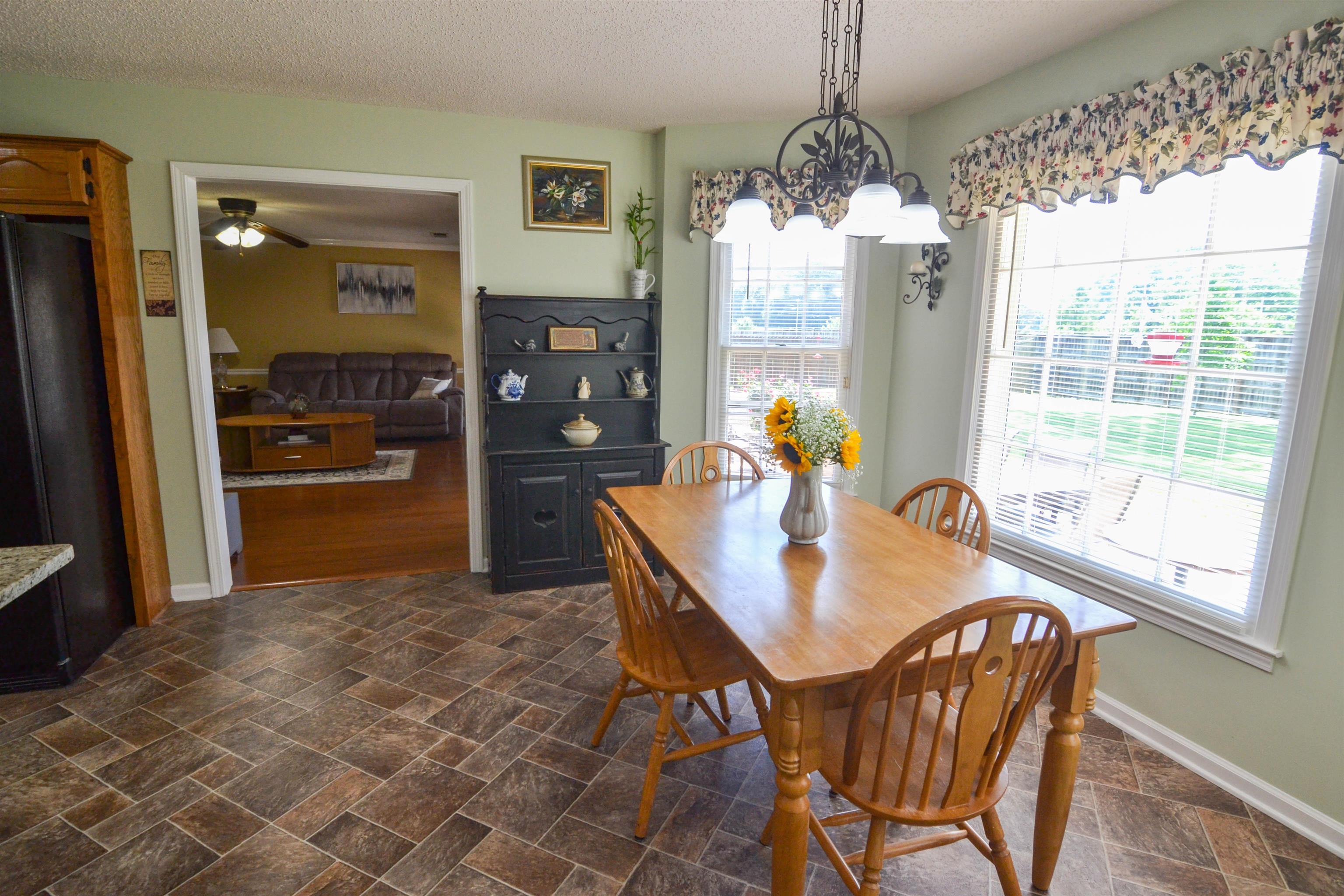 591 Rillbrook Drive Collierville, TN 38017 - Photo 11 of 25 a dining room with furniture a chandelier and window