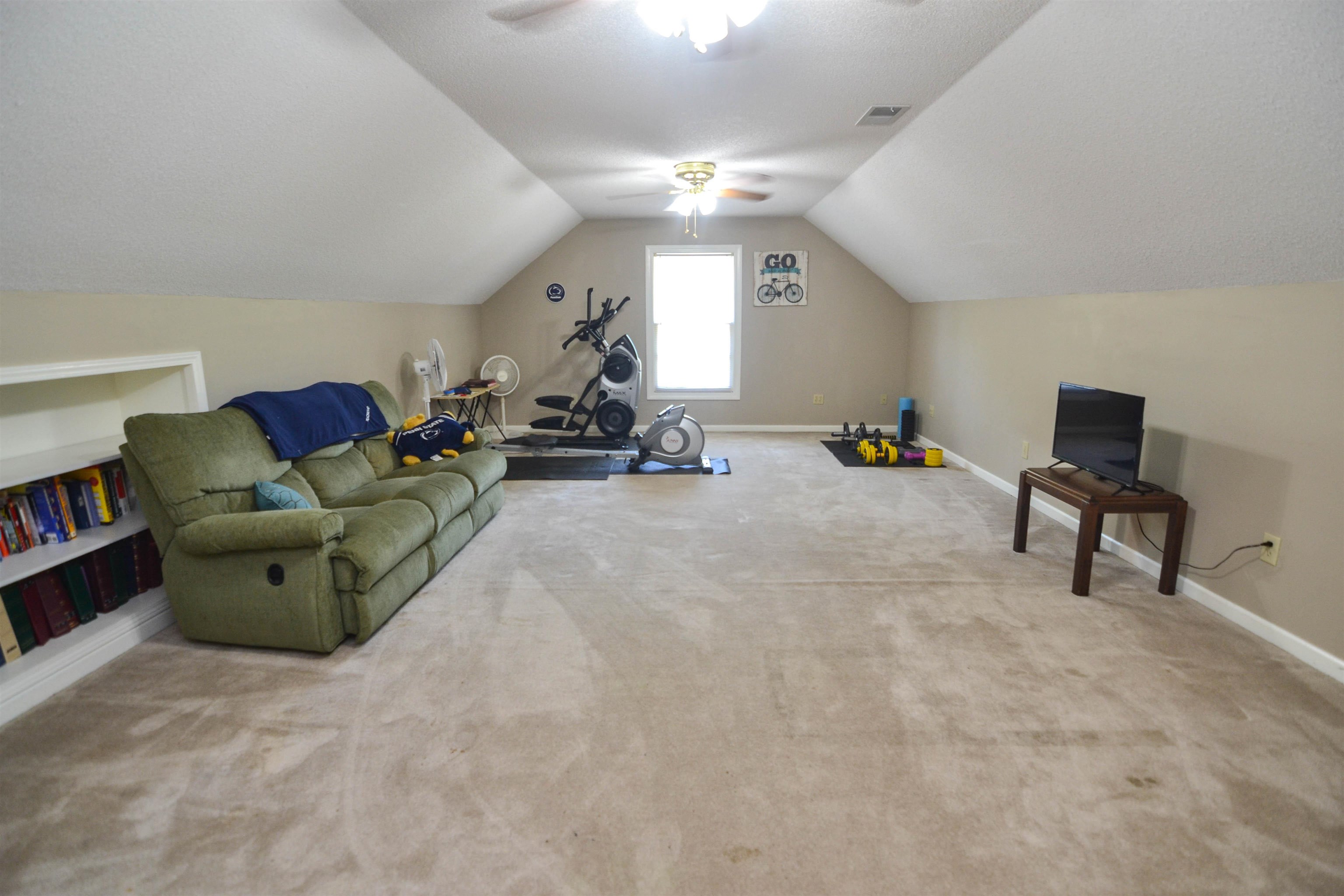 591 Rillbrook Drive Collierville, TN 38017 - Photo 21 of 25 a living room with furniture and a gym machine
