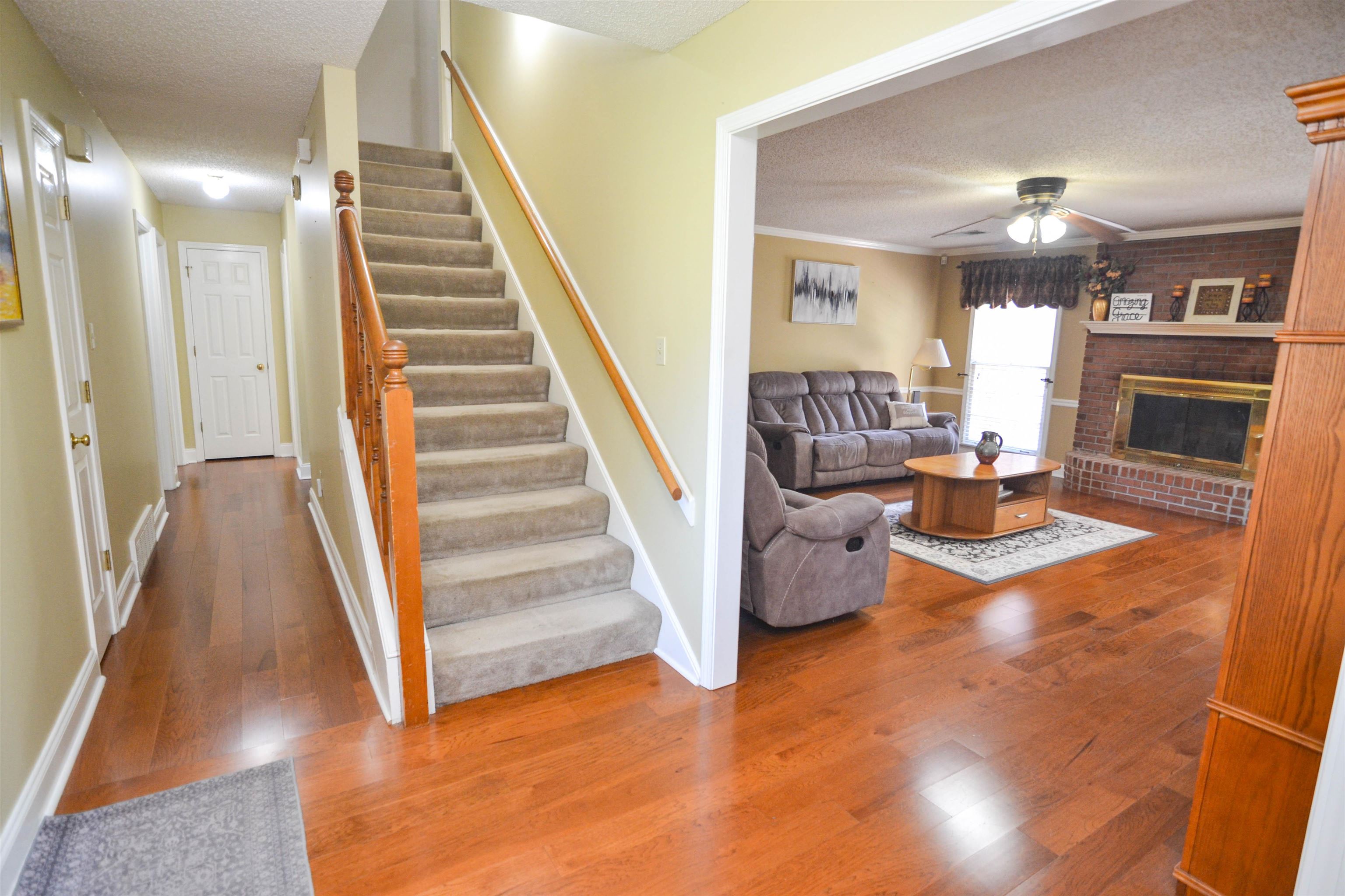 591 Rillbrook Drive Collierville, TN 38017 - Photo 3 of 25 a view of a livingroom with furniture staircase and kitchen view