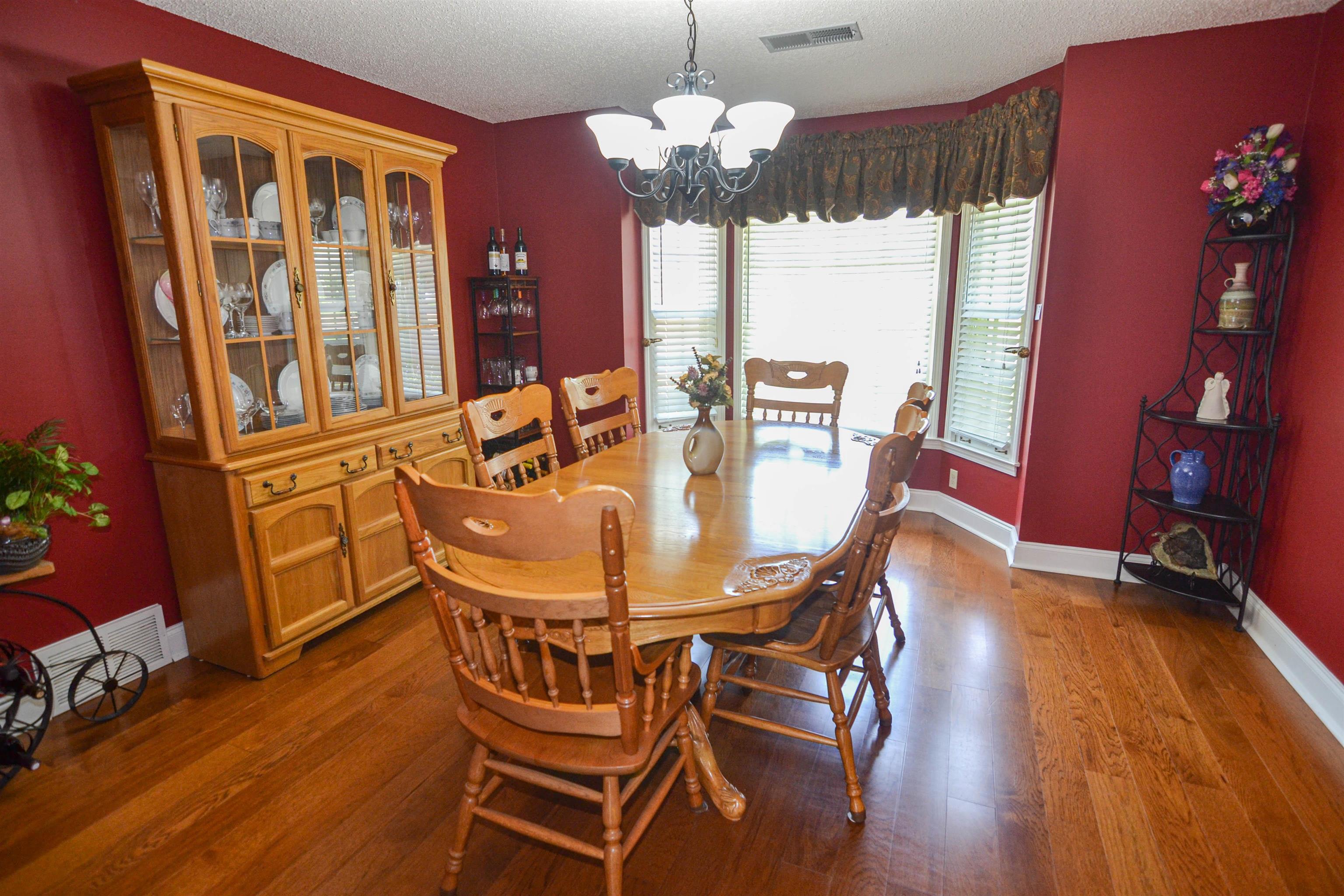 591 Rillbrook Drive Collierville, TN 38017 - Photo 6 of 25 a view of a dining room with furniture a chandelier and wooden floor