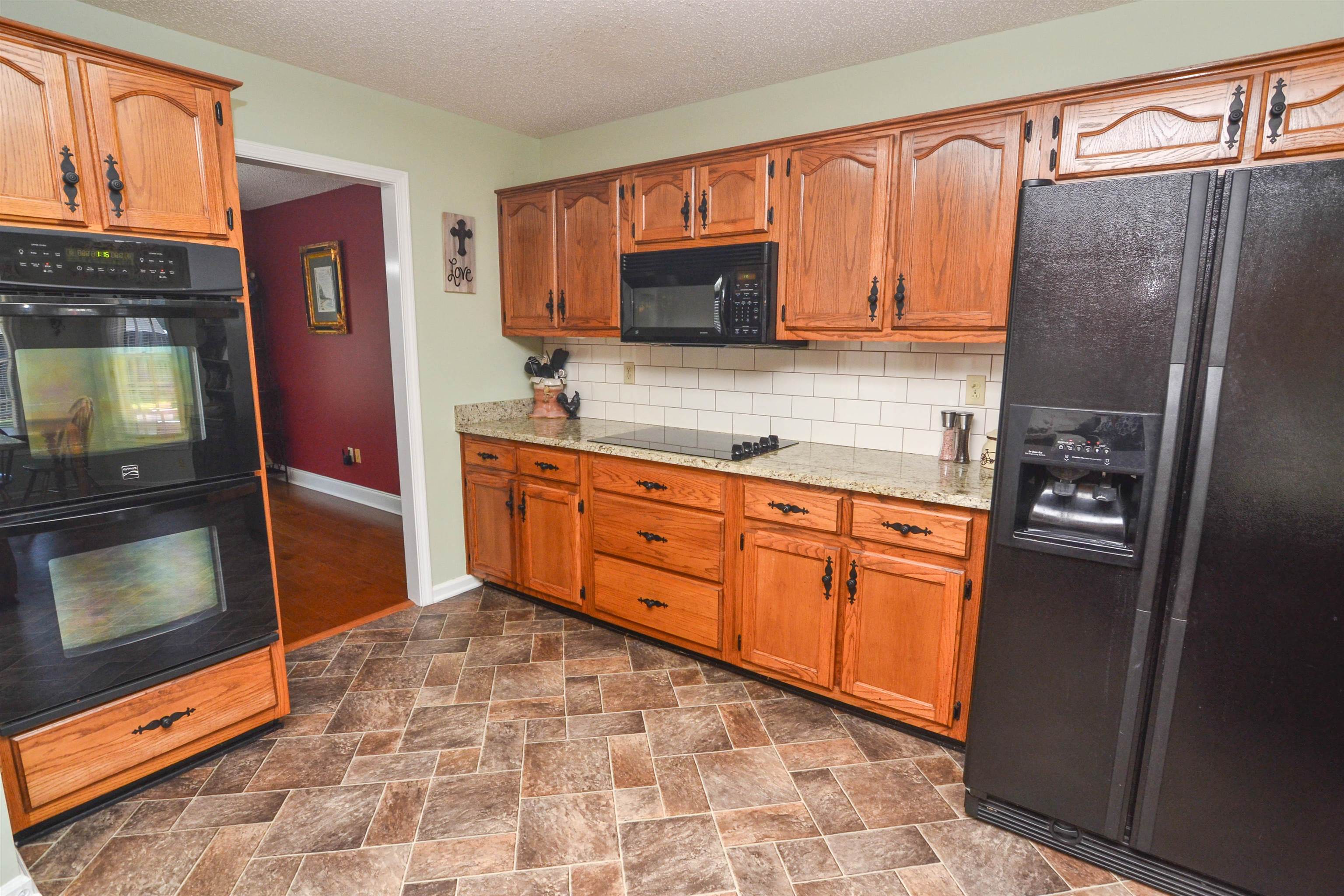 591 Rillbrook Drive Collierville, TN 38017 - Photo 8 of 25 a kitchen with granite countertop a refrigerator stove and sink