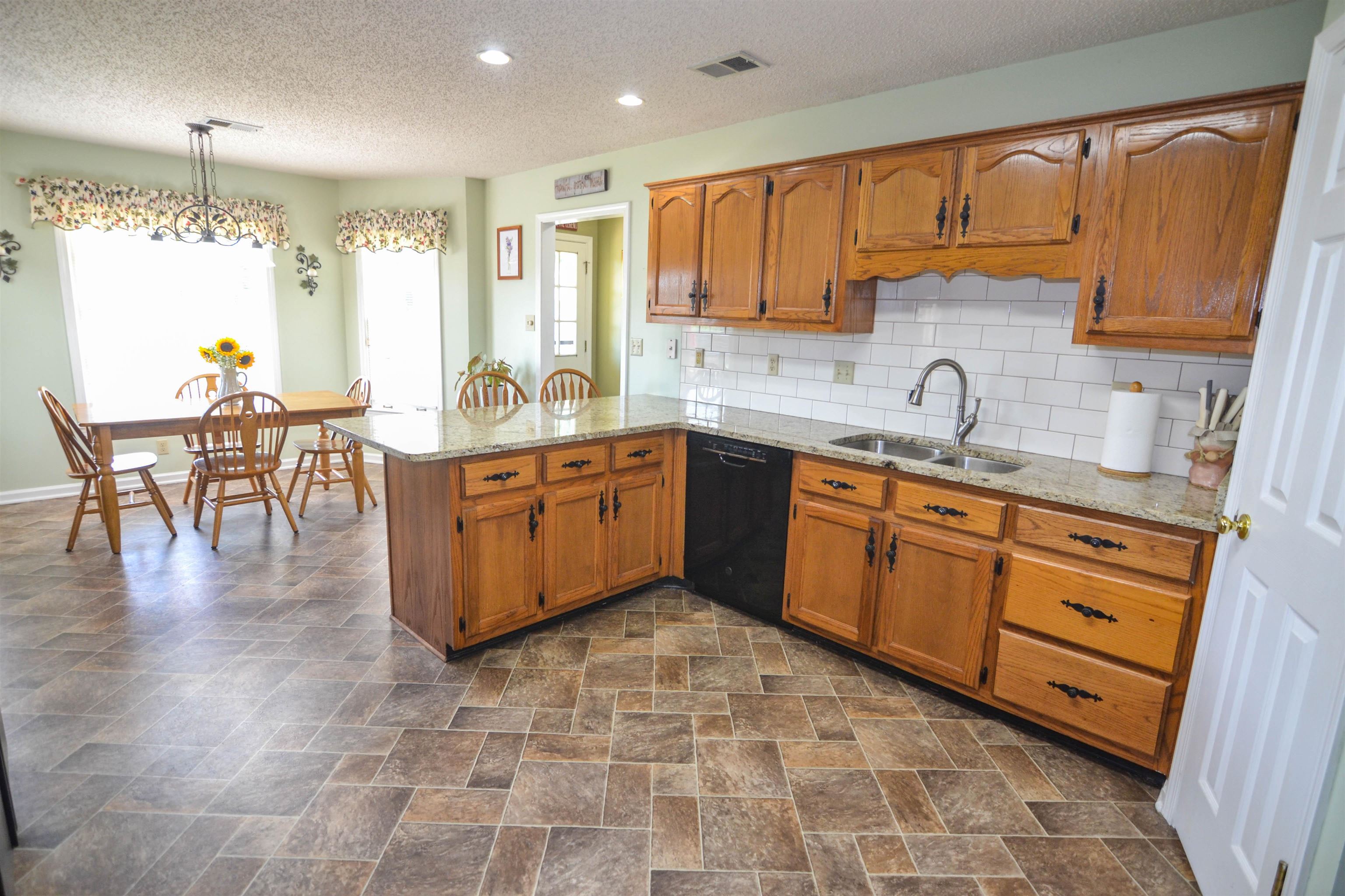 591 Rillbrook Drive Collierville, TN 38017 - Photo 9 of 25 a kitchen with stainless steel appliances granite countertop a sink cabinets and wooden floor