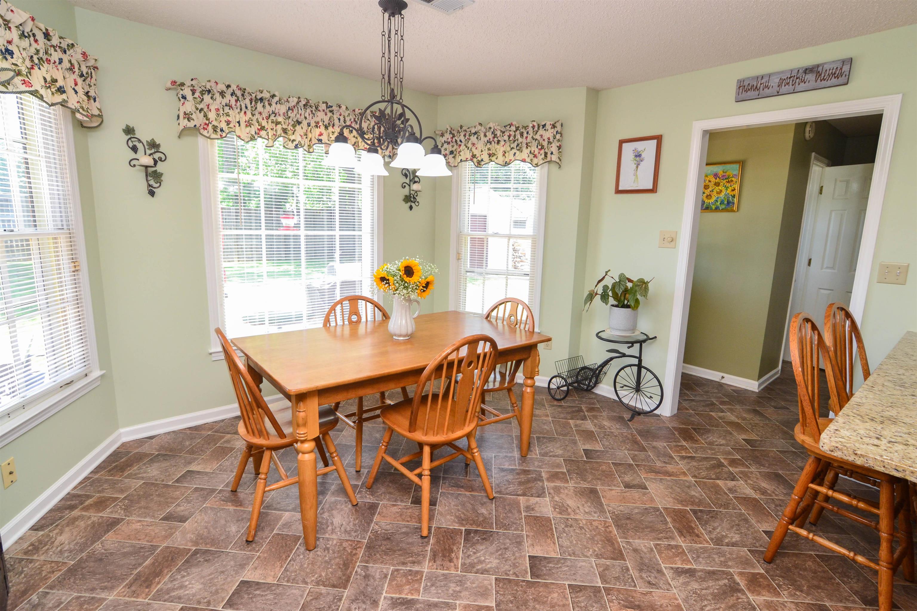 591 Rillbrook Drive Collierville, TN 38017 - Photo 10 of 25 a view of a dining room with furniture and wooden floor