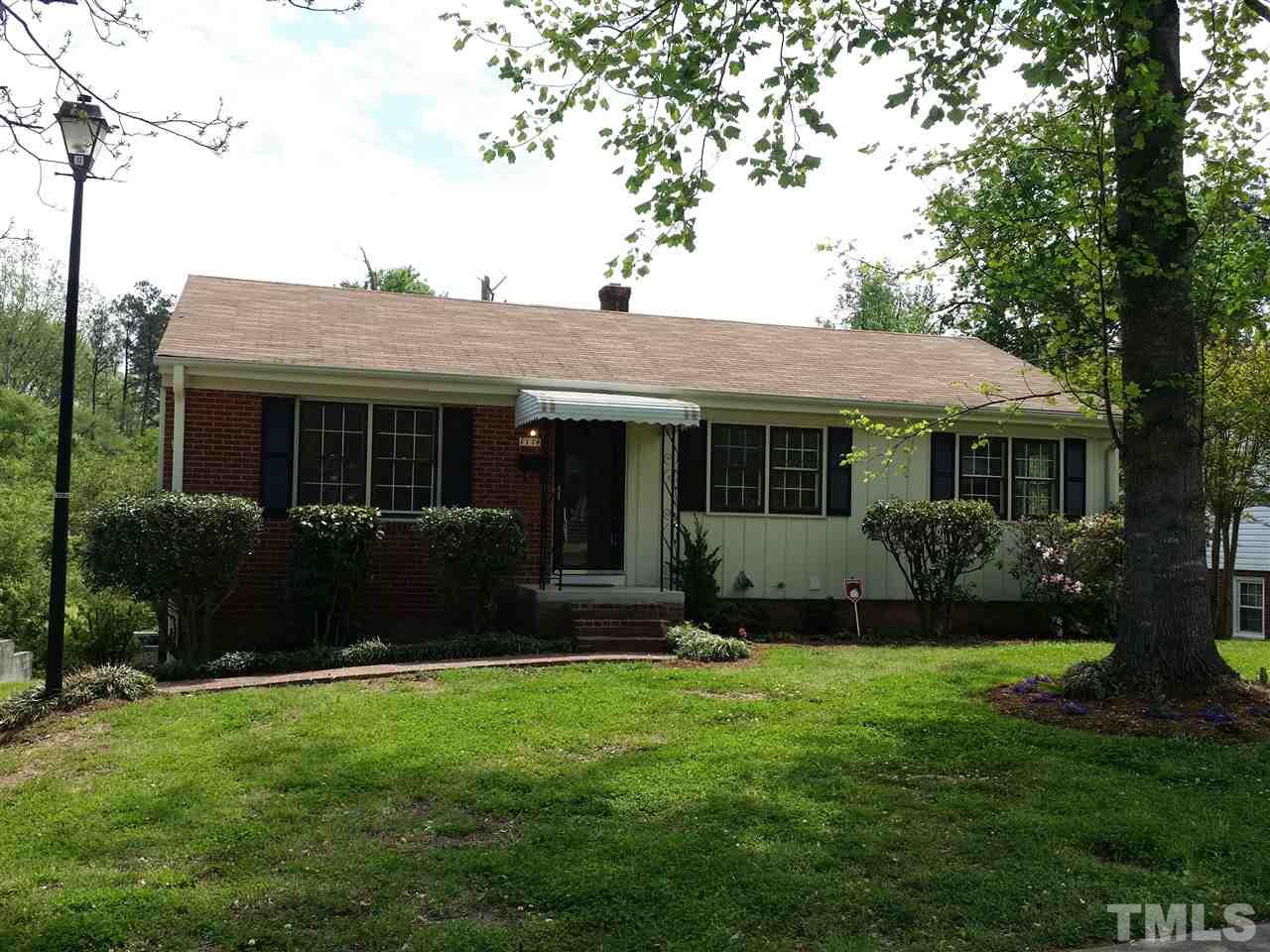 1114 North King Charles Road Raleigh, NC 27610 - Photo 1 of 13 a front view of a house with a garden and yard