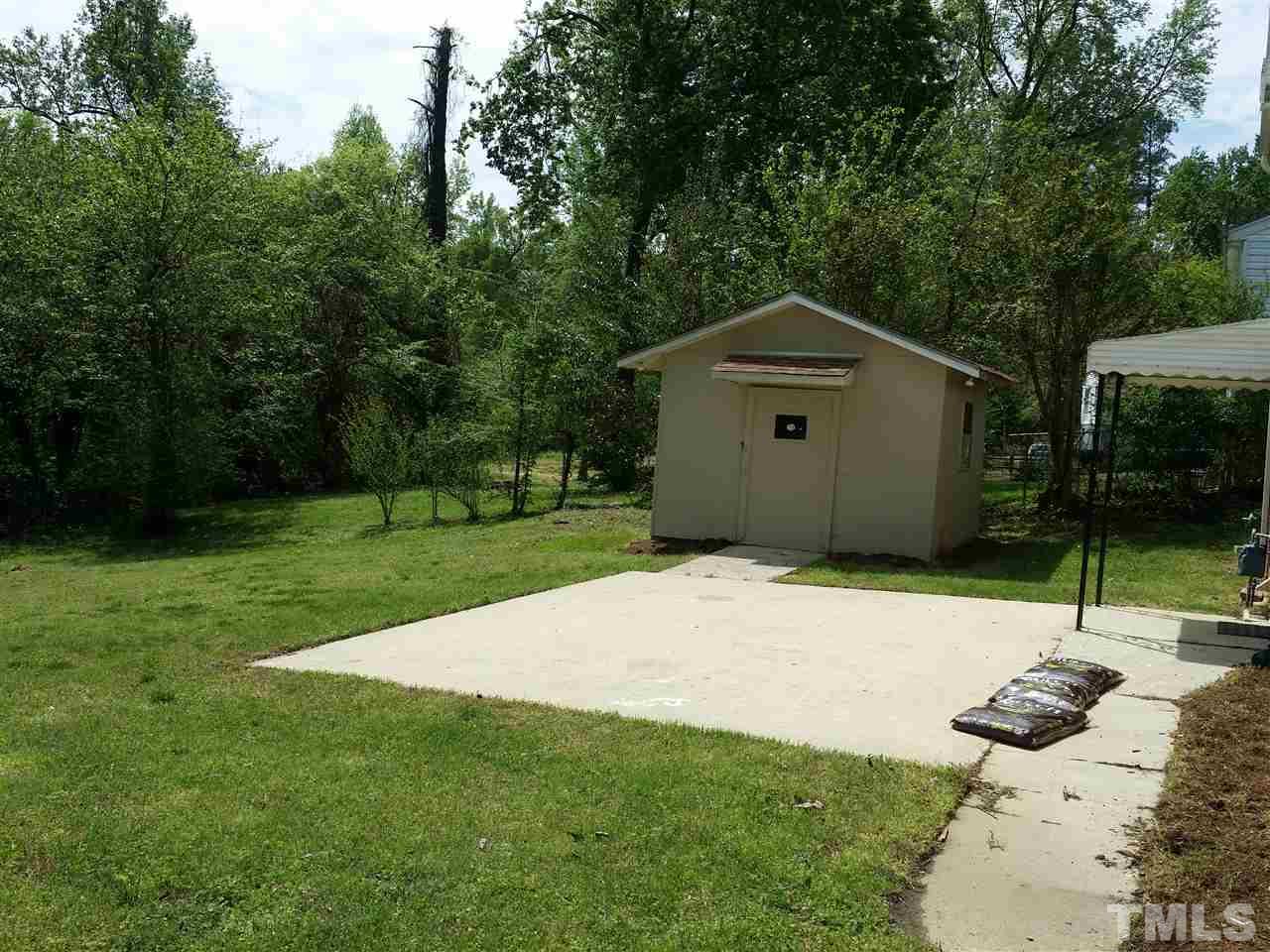 1114 North King Charles Road Raleigh, NC 27610 - Photo 11 of 13 a front view of a house with a yard