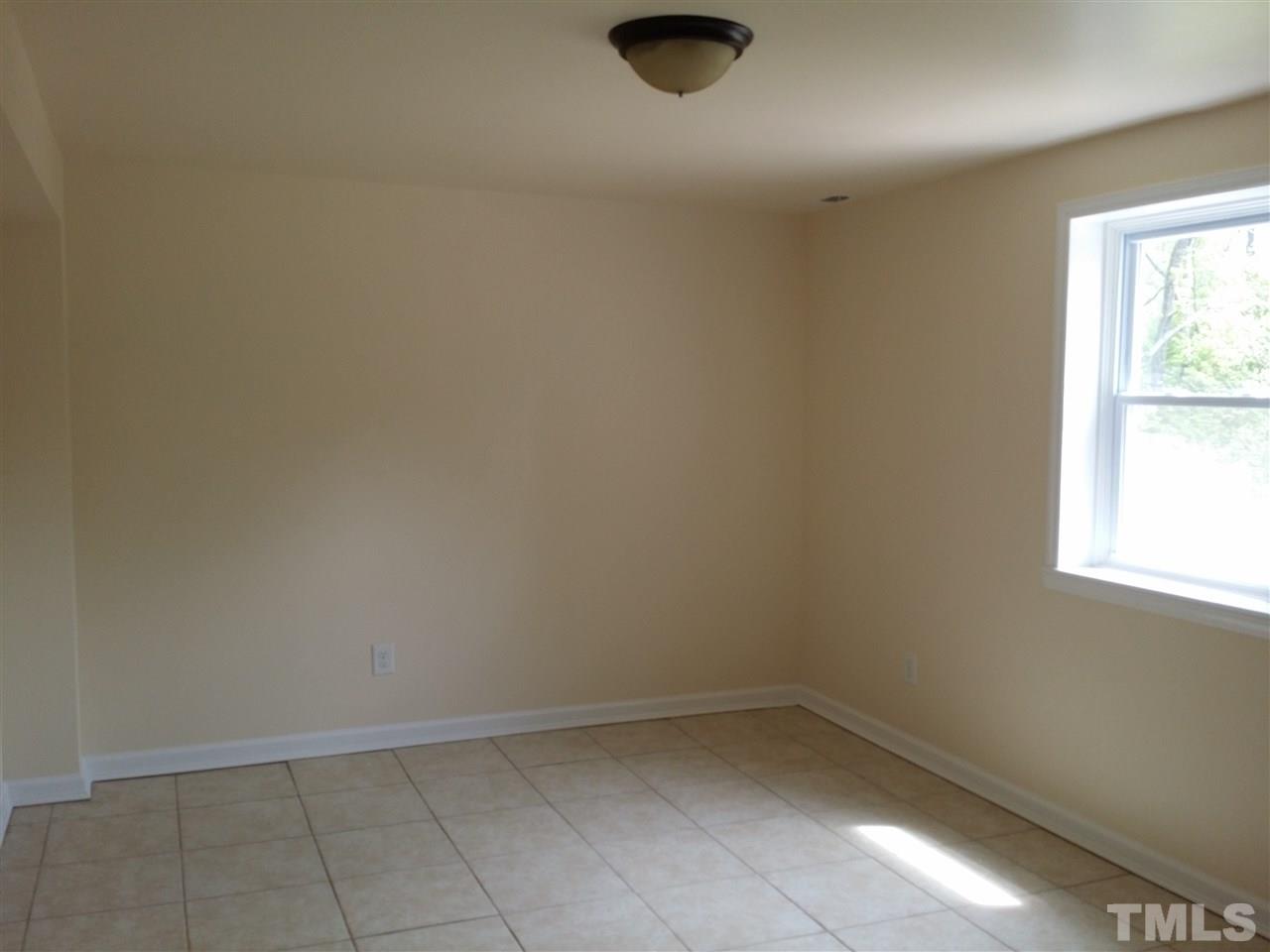 1114 North King Charles Road Raleigh, NC 27610 - Photo 6 of 13 an empty room with a workbench