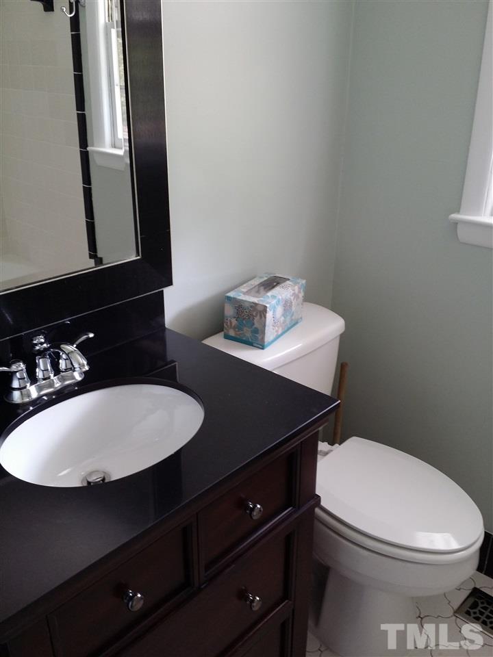 1114 North King Charles Road Raleigh, NC 27610 - Photo 7 of 13 a bathroom with a sink a toilet and mirror