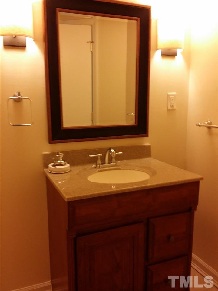 1114 North King Charles Road Raleigh, NC 27610 - Photo 8 of 13 a bathroom with a sink and a mirror
