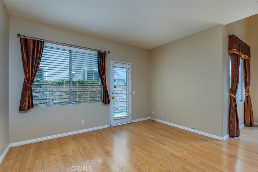 1654 Rush Haven Way Simi Valley, CA 93065 - Photo 12 of 32 an empty room with wooden floor and windows