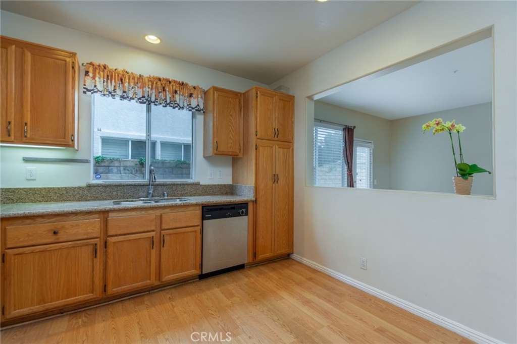 1654 Rush Haven Way Simi Valley, CA 93065 - Photo 14 of 32 a kitchen with granite countertop a sink and cabinets