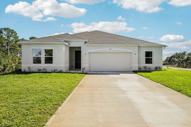16492 Crane Road Weeki Wachee, FL 34614 - Photo 1 of 24 a front view of a house with a garden and yard